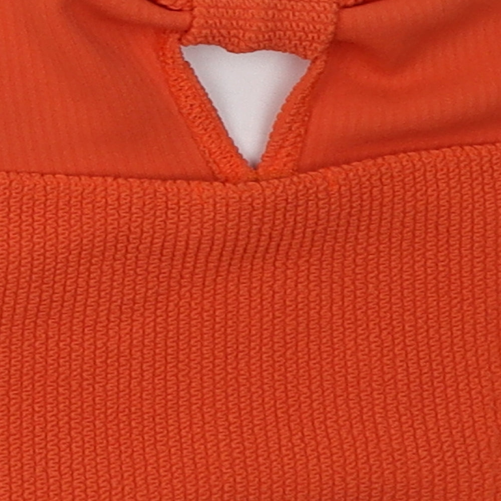 Brand and care label for Boohoo women’s orange polyester cropped tank, size UK 12, off the shoulder