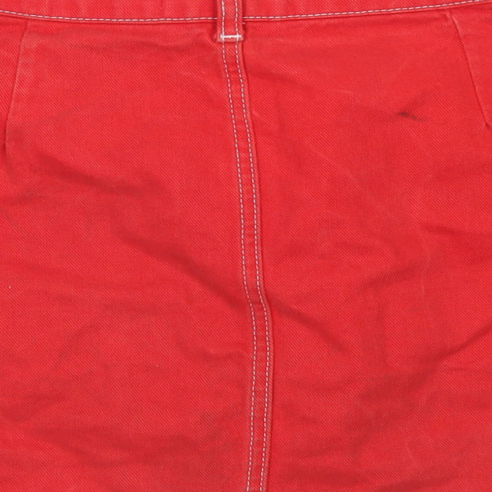 Brand and care label for BDG women’s red cotton a-line skirt, size M, button