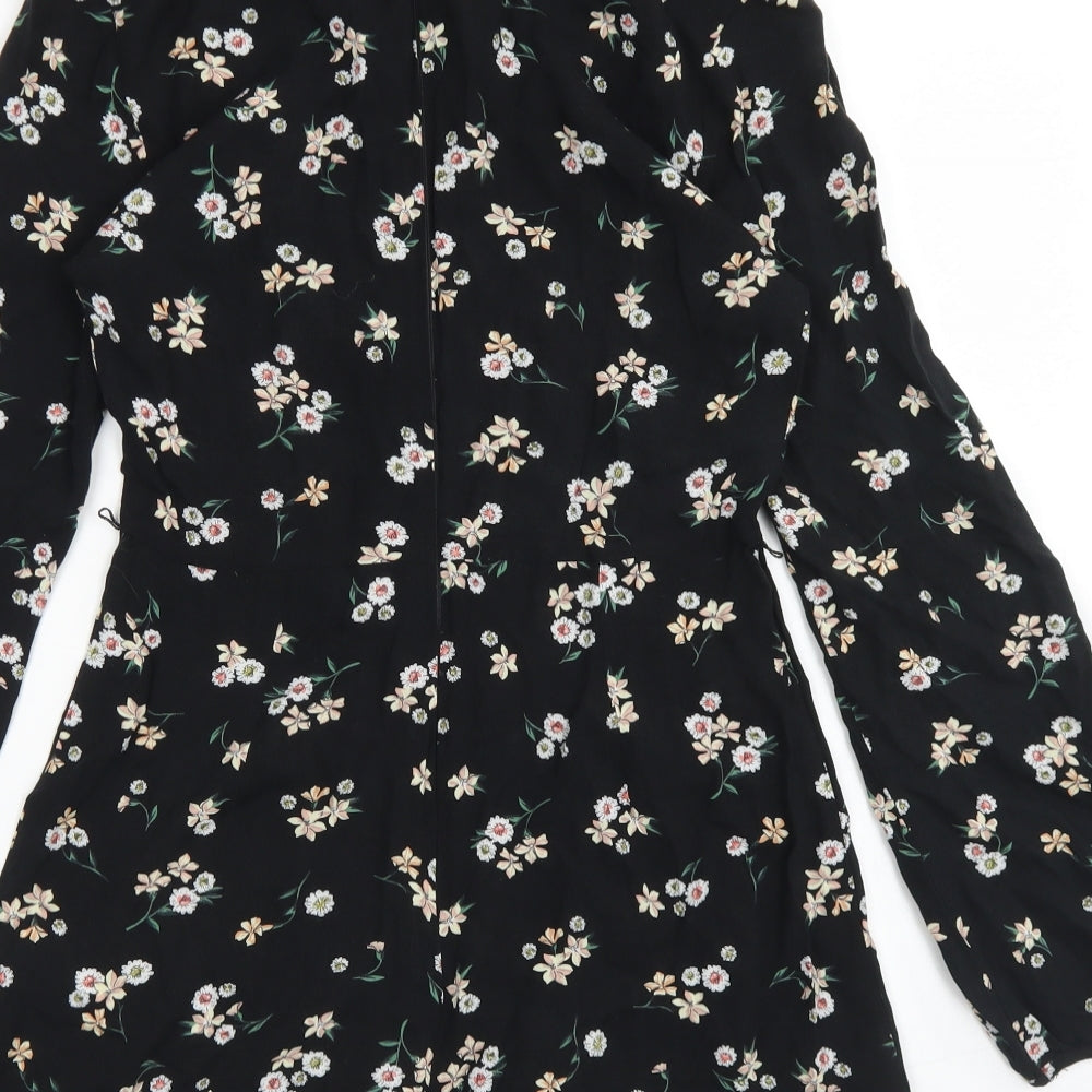 Brand and care label for Topshop women’s black floral viscose romper one-piece, size UK 6, zip