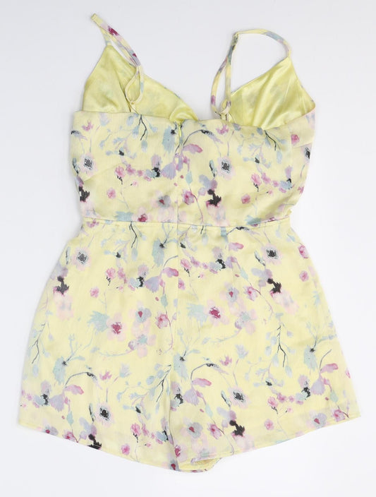 Back view of Missguided women’s yellow floral polyester playsuit one-piece, size UK 8, 3-inch leg zip