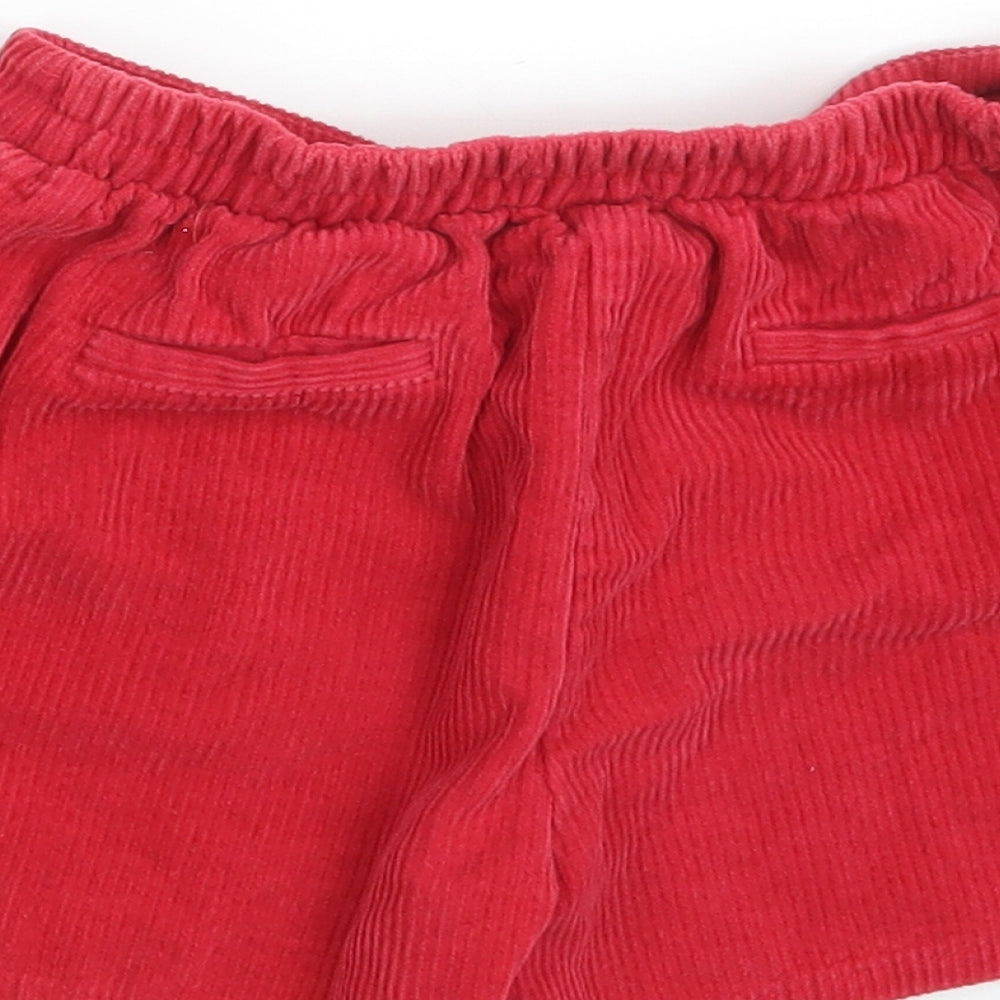 Brand and care label for Nutmeg girls’ red 100% cotton mini set, size 8-9, years regular