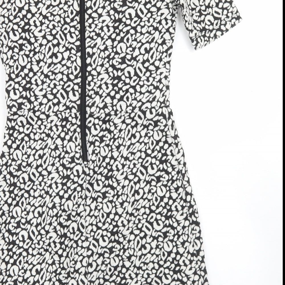 Brand and care label for H&M women’s black animal print polyester skater dress, size UK 8, round neck zip