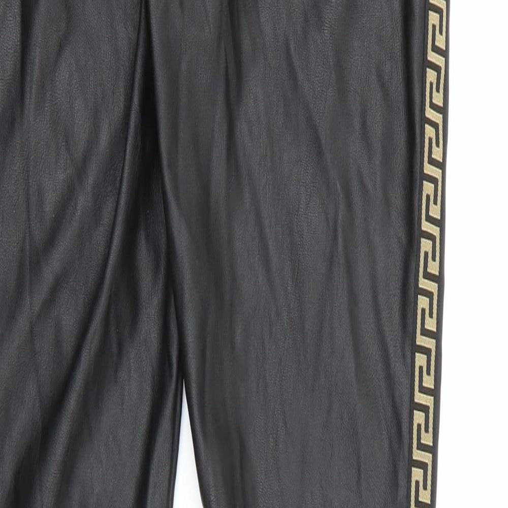 Brand and care label for In Vogue women’s black polyester jegging trousers, size M, 27-inch leg regular button