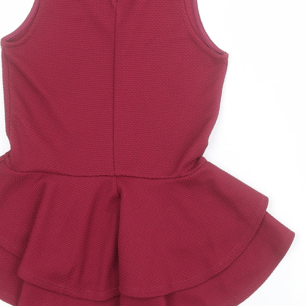 Brand and care label for Miss Selfridge women’s red polyester basic blouse, size UK 4, round neck - peplum
