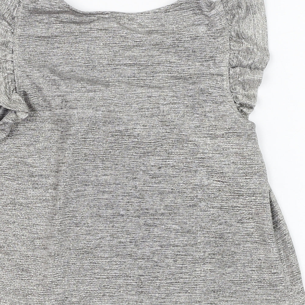 Brand and care label for F&F girls’ silver polyester basic blouse, size 9-10, years round neck pullover