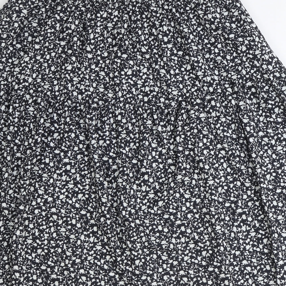 Brand and care label for SheIn women’s black floral polyester peasant skirt, size S