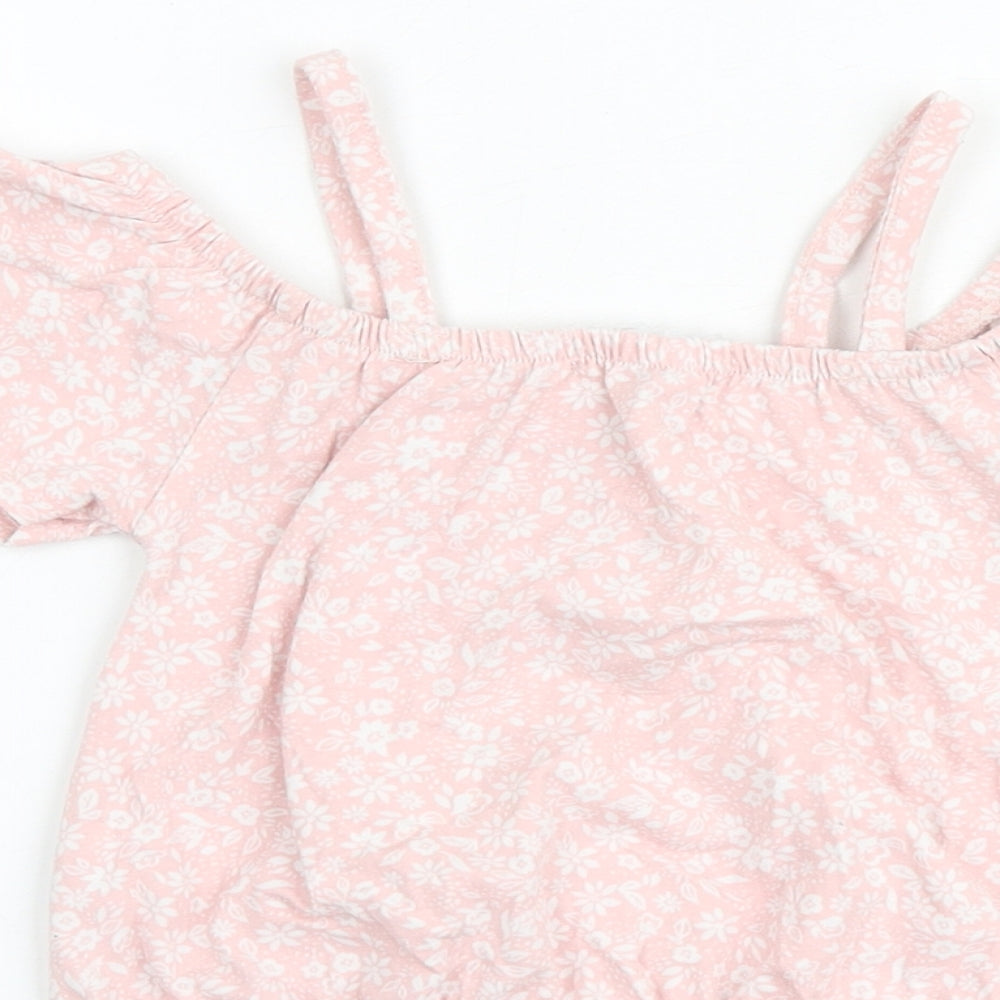 Brand and care label for Btween girls’ pink floral cotton basic blouse, size 6, years round neck pullover - cold shoulder