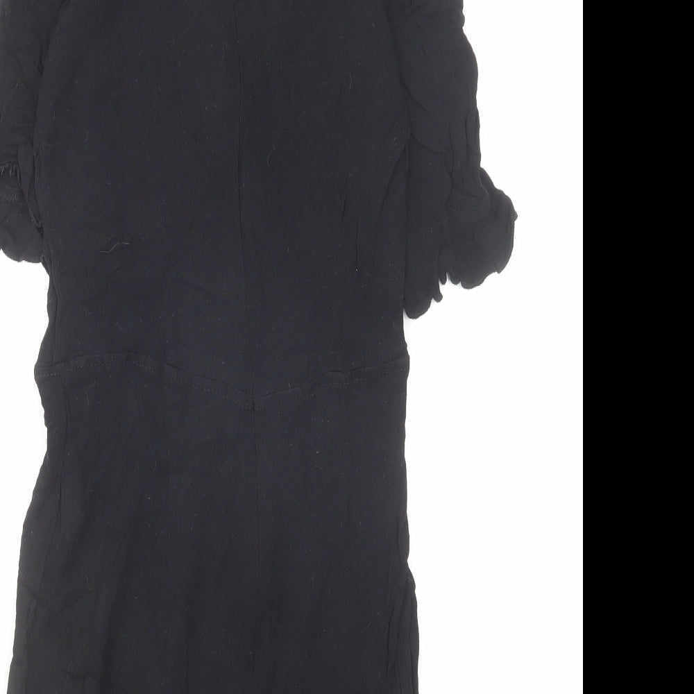 Brand and care label for Missguided women’s black viscose playsuit one-piece, size UK 6, zip