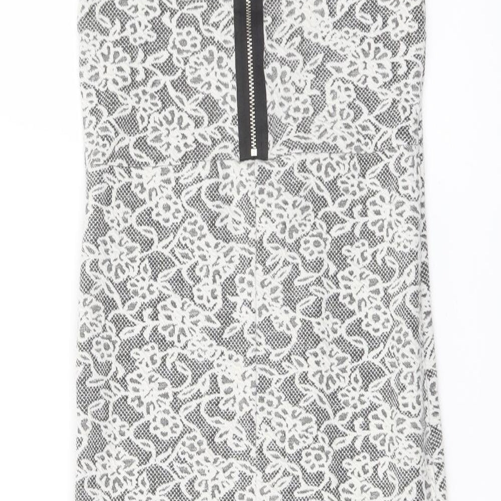 Brand and care label for Miss Selfridge women’s white floral cotton bodycon, size UK 8, crew neck zip
