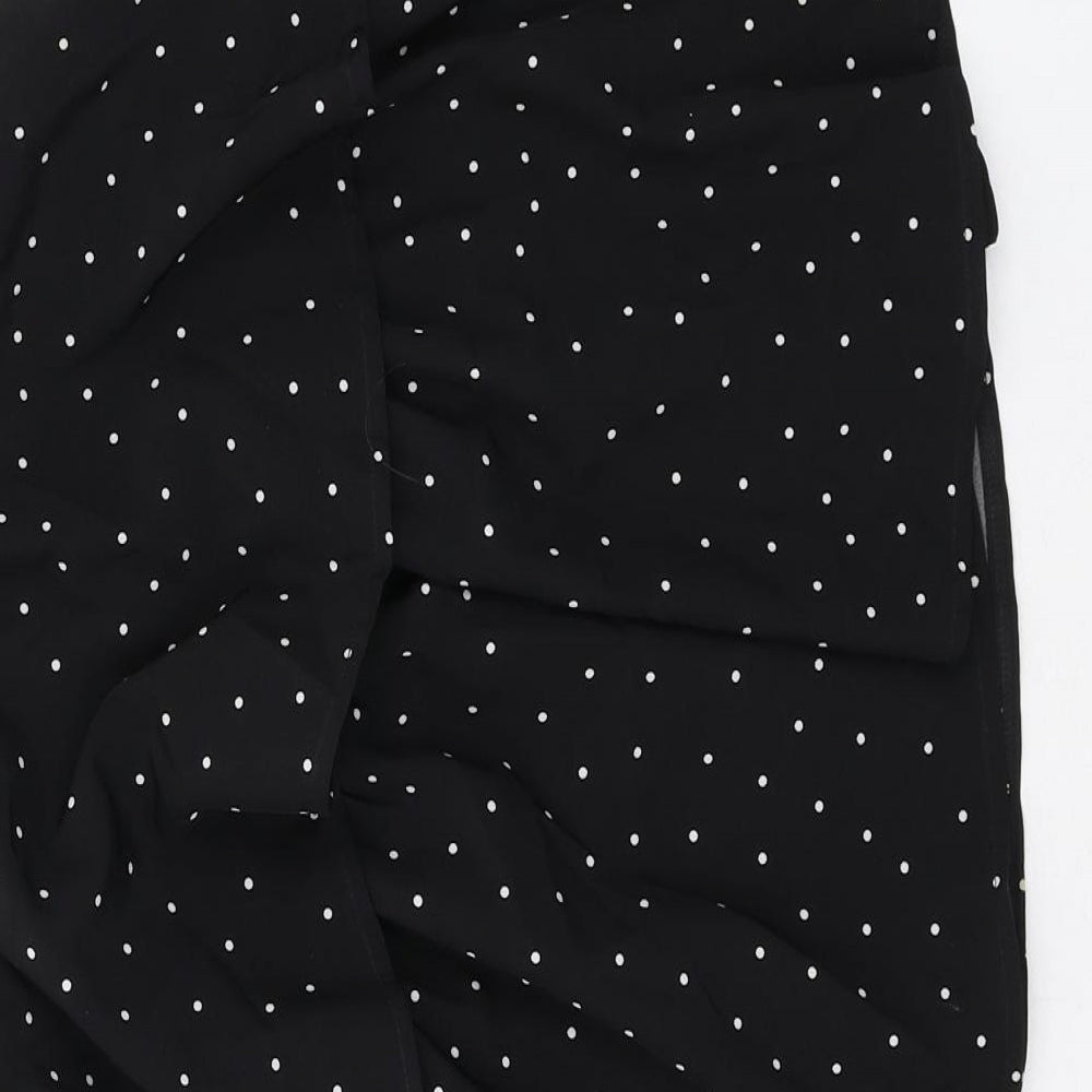 Brand and care label for In the Style women’s black polka dot polyester a-line skirt, size UK 8