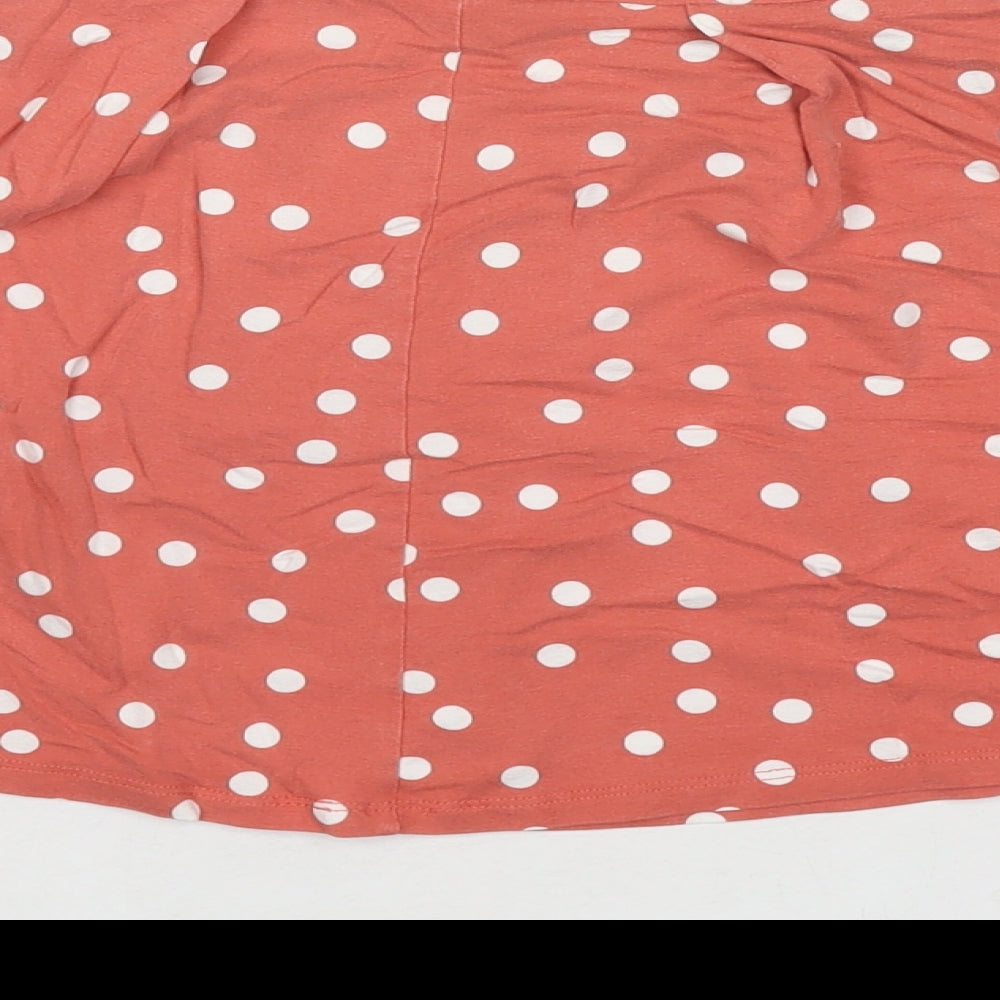 Brand and care label for ASOS women’s orange polka dot cotton skater skirt, size UK 6