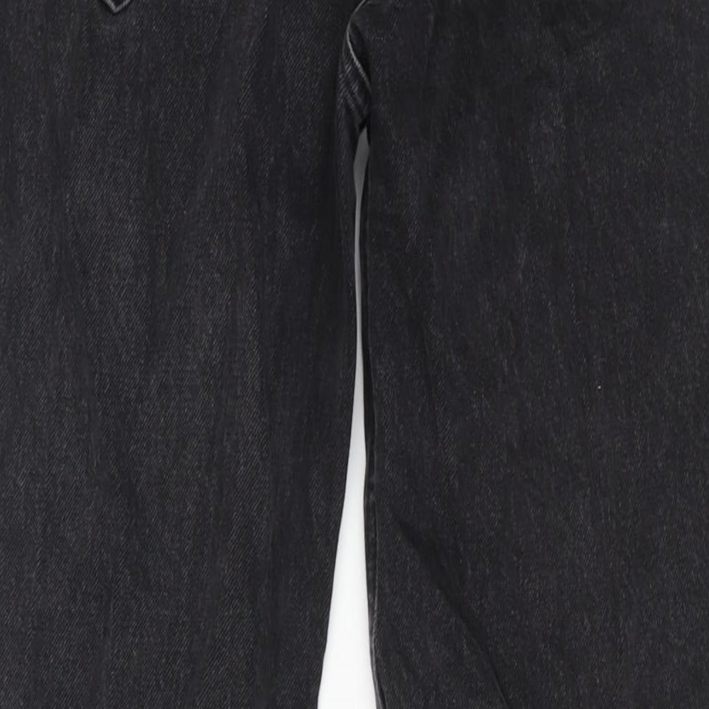 Brand and care label for BDG men’s black cotton tapered jeans, size 30, in, 32-inch leg regular zip