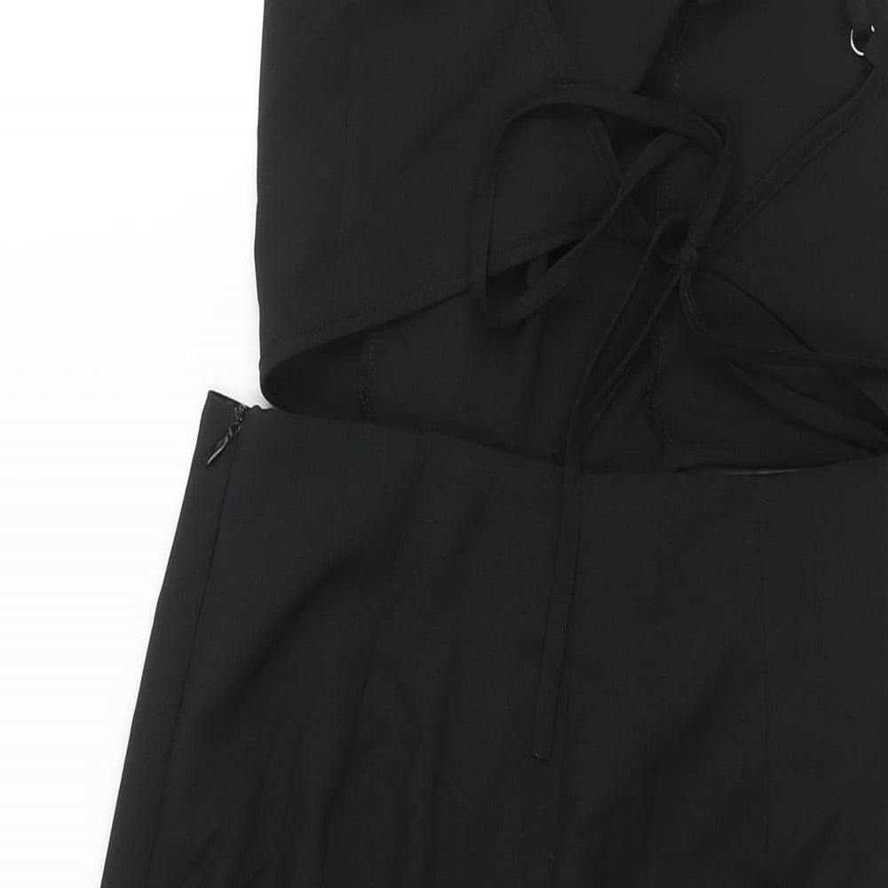 Brand and care label for Missguided women’s black polyester jumpsuit one-piece, size UK 6, 16-inch leg zip - cut out