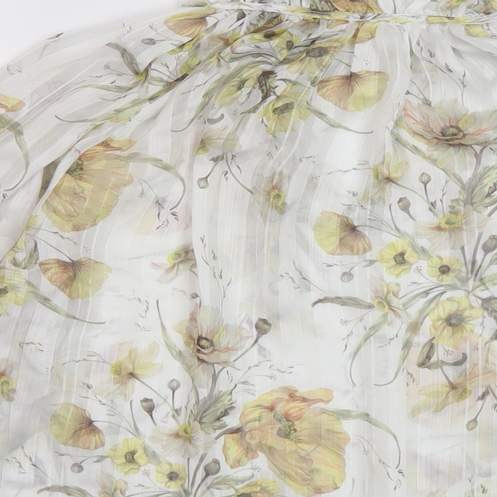 Brand and care label for H7&M women’s white floral polyester basic blouse, size UK 6, mock neck