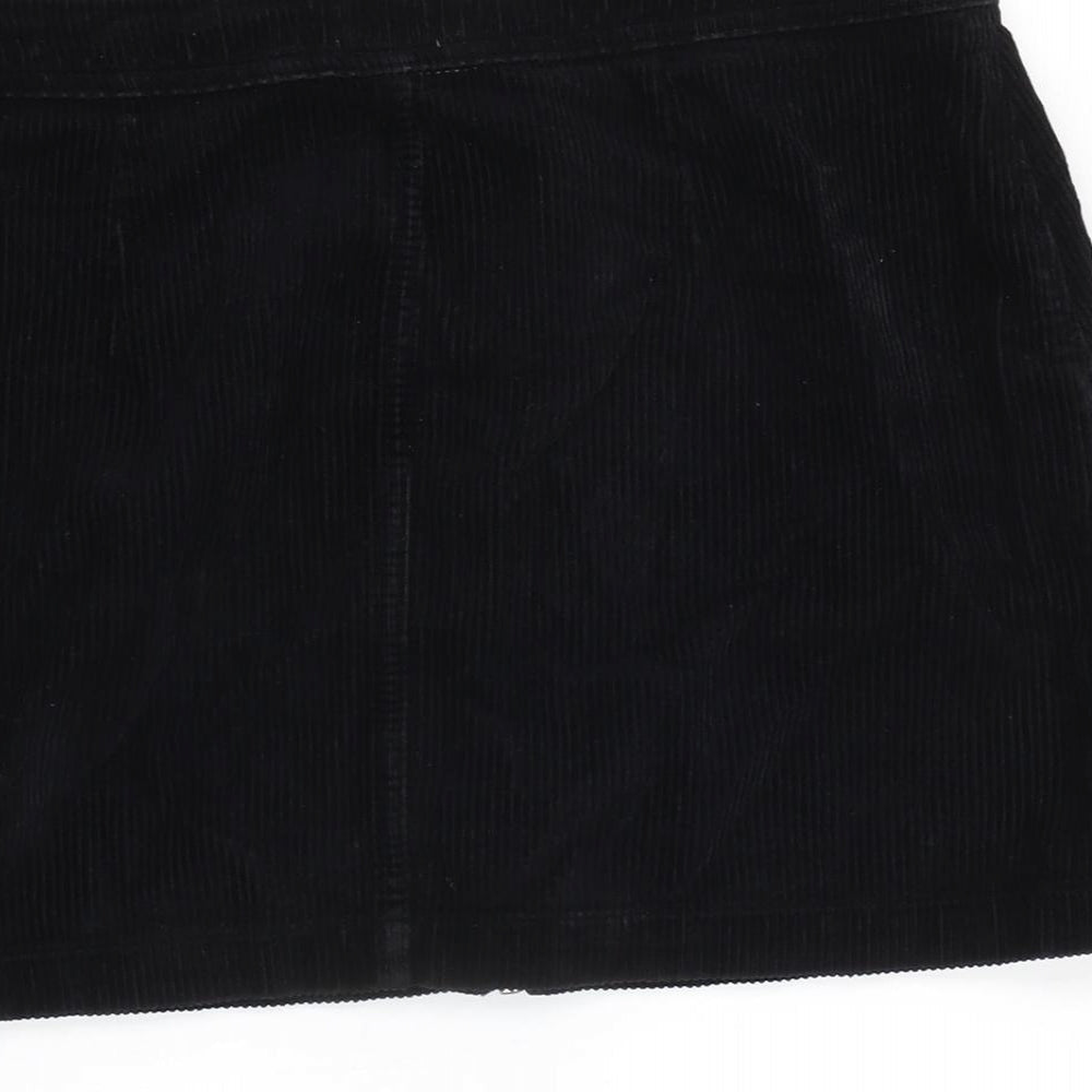 Brand and care label for BDG women’s black cotton a-line skirt, size M, zip