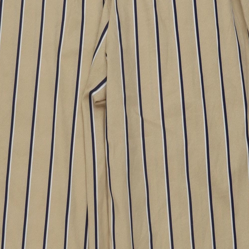 Brand and care label for Missguided women’s beige striped polyester trousers, size UK 6, 31-inch leg regular