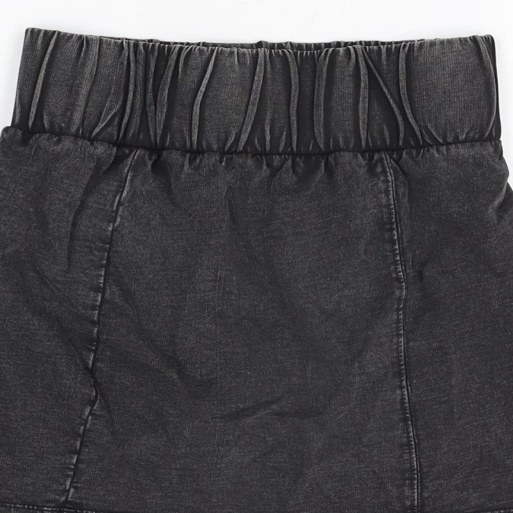 Brand and care label for ASOS women’s black cotton mini skirt, size UK 10