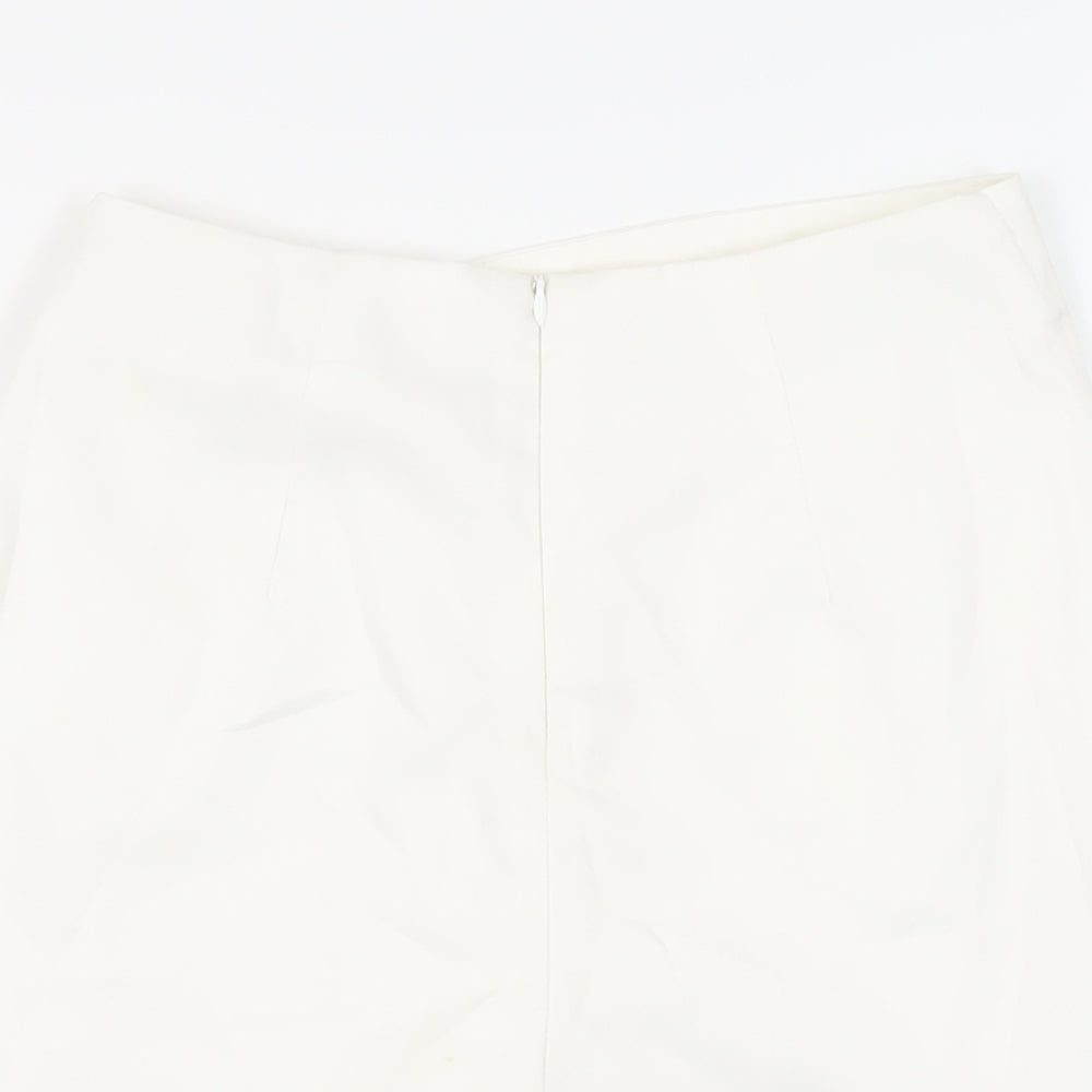 Brand and care label for Missguided women’s white polyester skort skirt, size UK 6, zip