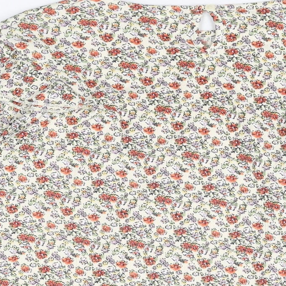 Brand and care label for Zara girls’ ivory floral polyester basic t-shirt, size 13-14, years round neck button