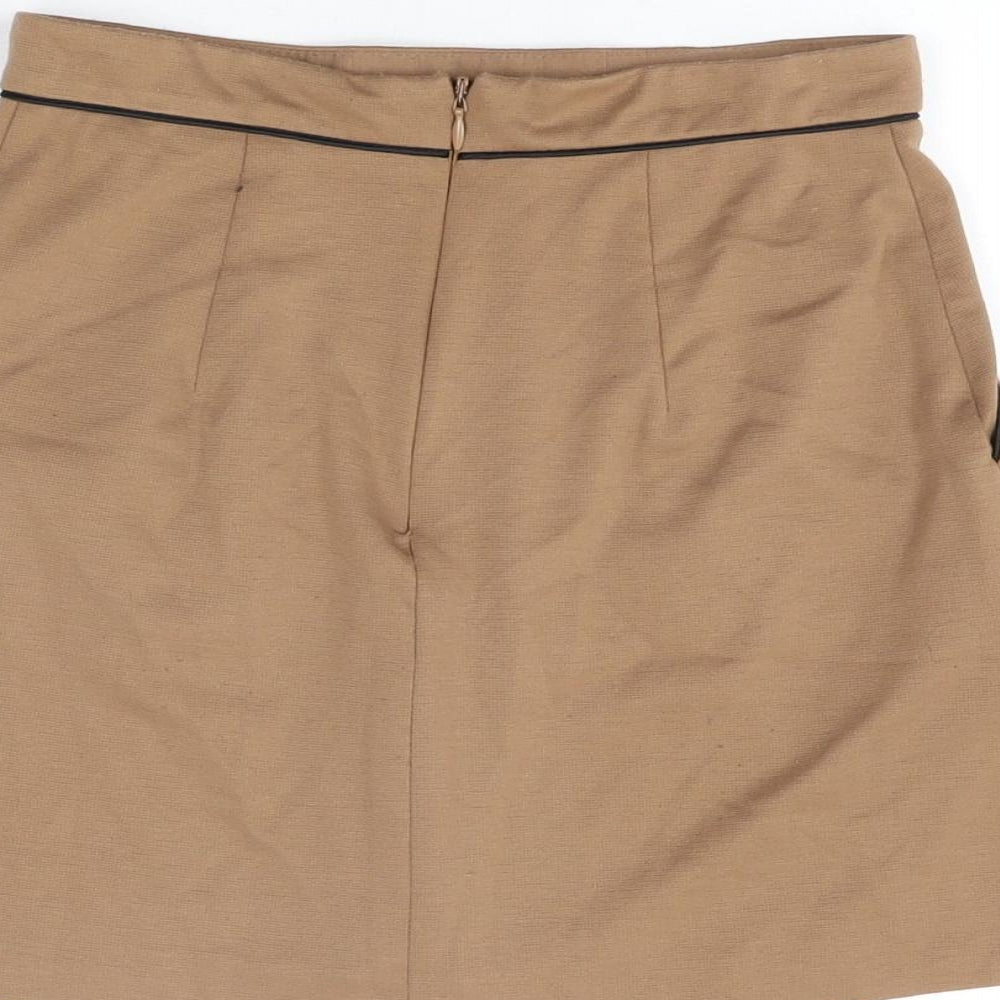 Brand and care label for Miss Selfridge women’s beige polyester mini skirt, size UK 4, zip