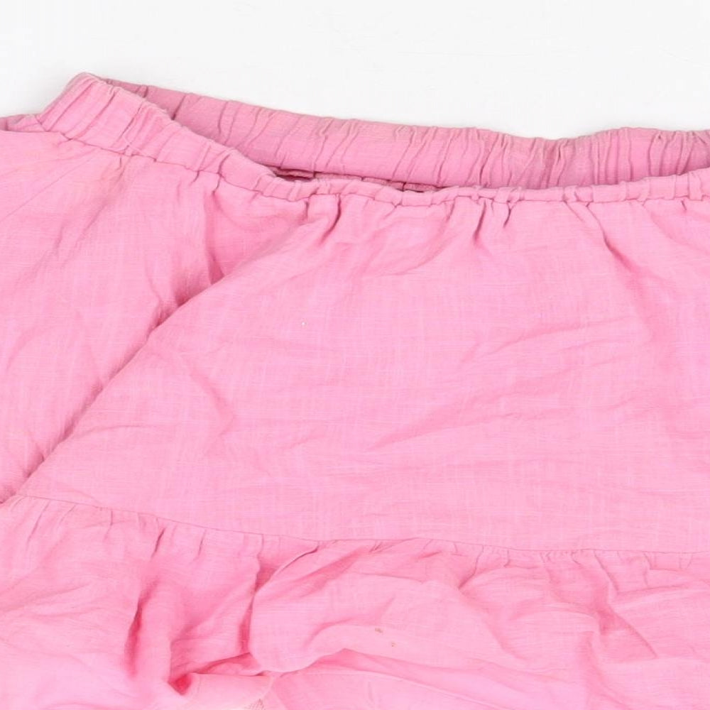 Brand and care label for In the Style women’s pink cotton mini skirt, size UK 10