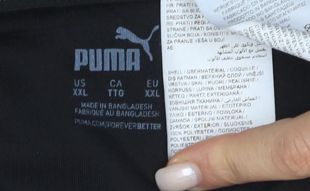 Close-up detail of Puma unisex black t-shirt, size 14, moisture wicking