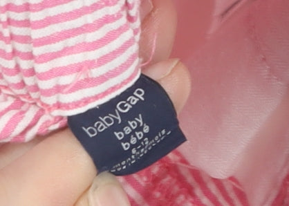 Brand and care label for Gap unisex baby pink striped shorts 6-12 months