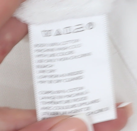 Brand and care label for BDG Women's White Button-Up Shirt, M, Casual Style