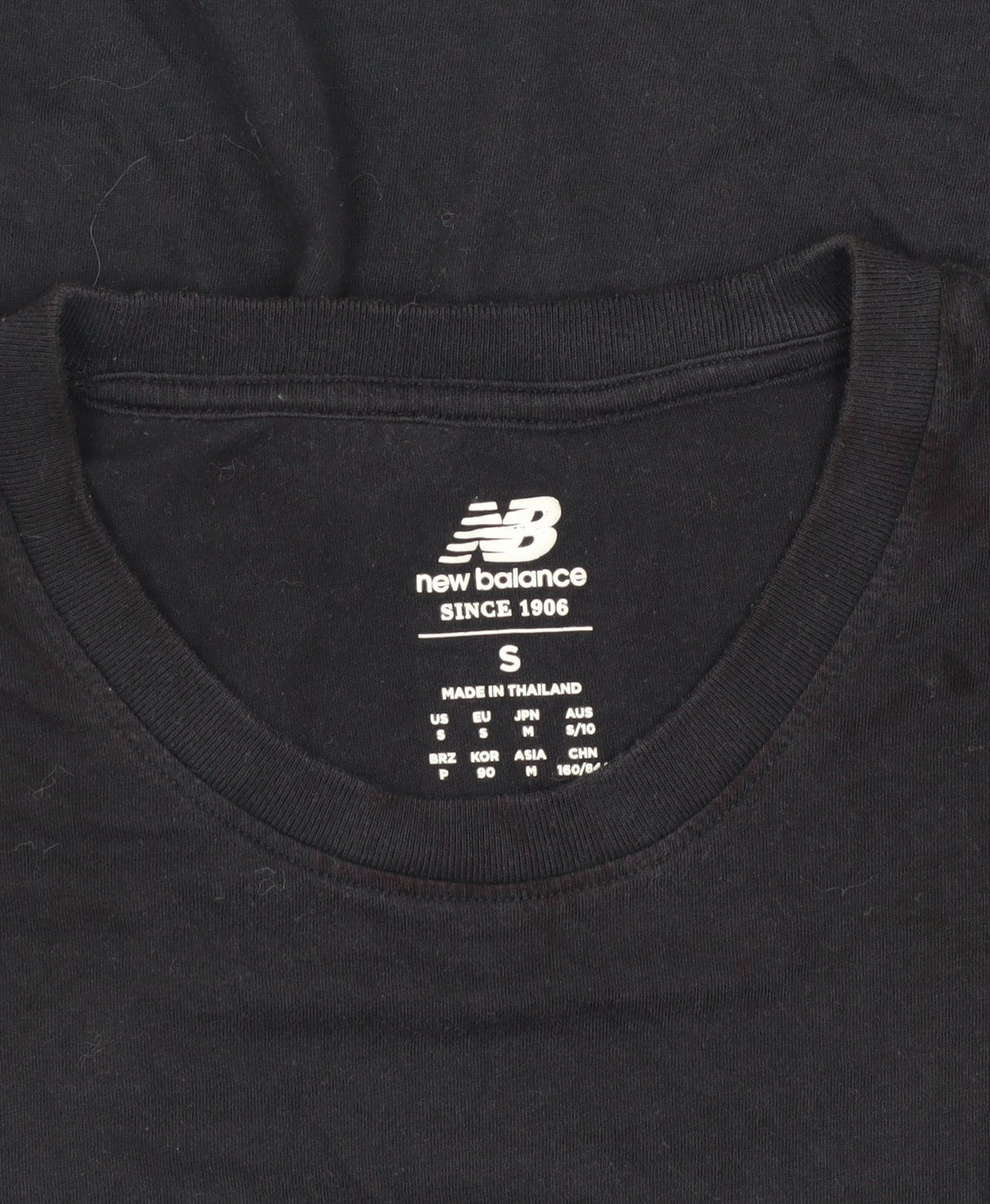 Close-up detail of New Balance unisex black t-shirt small regular fit