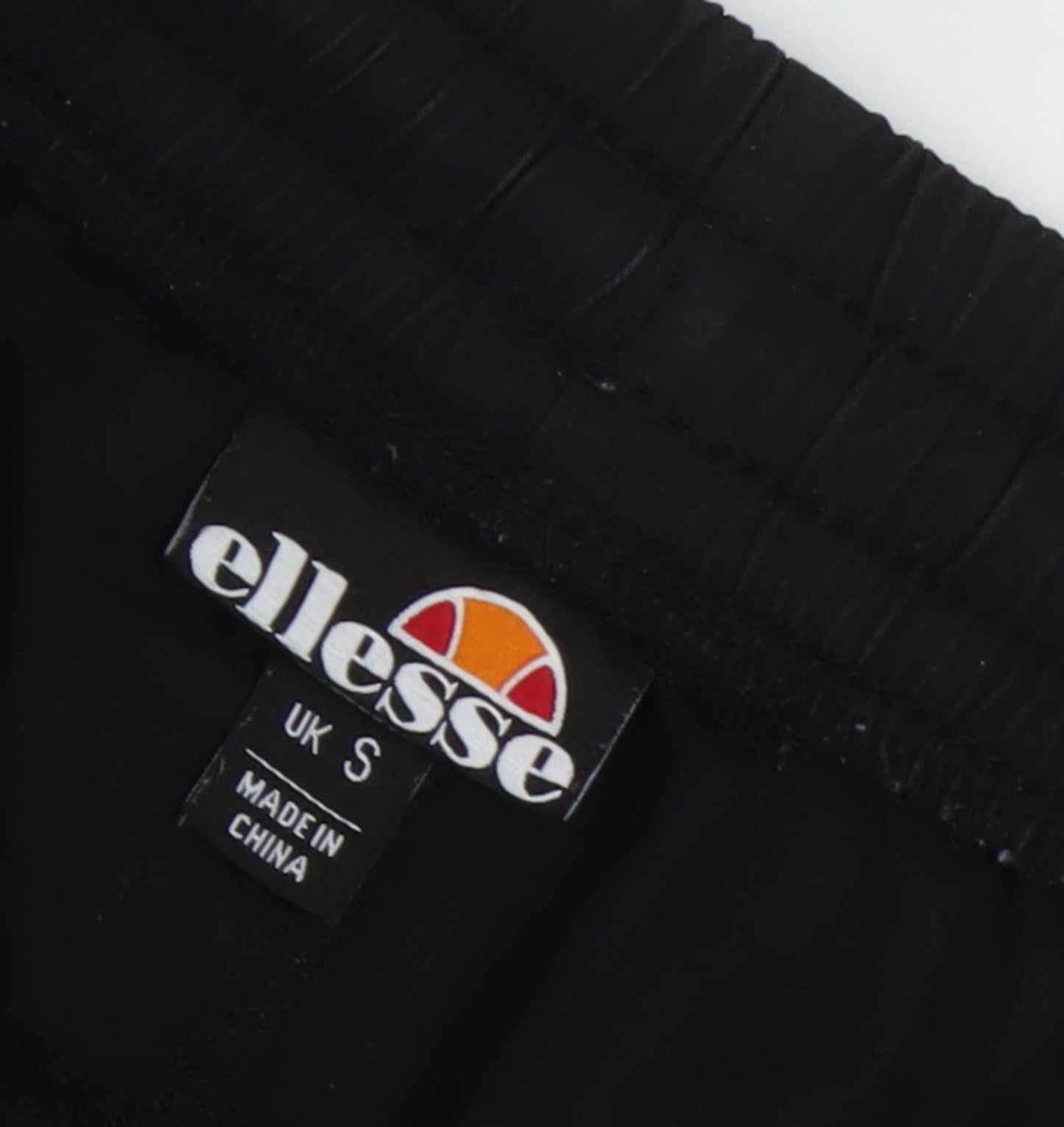 Close-up detail of Ellesse men’s black jogger trousers s