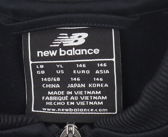 Close-up detail of New Balance boys’ black track jacket 12y polyester zip