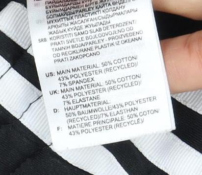 Brand and care label for Adidas unisex black track pants, size 10, athletic style