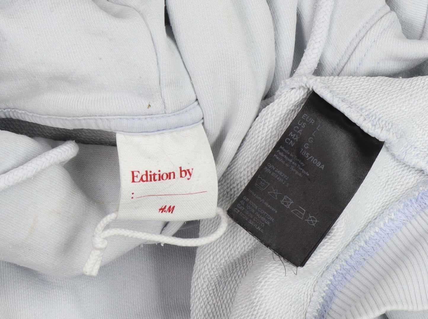 Close-up detail of H&M unisex adults white pullover hoodie l