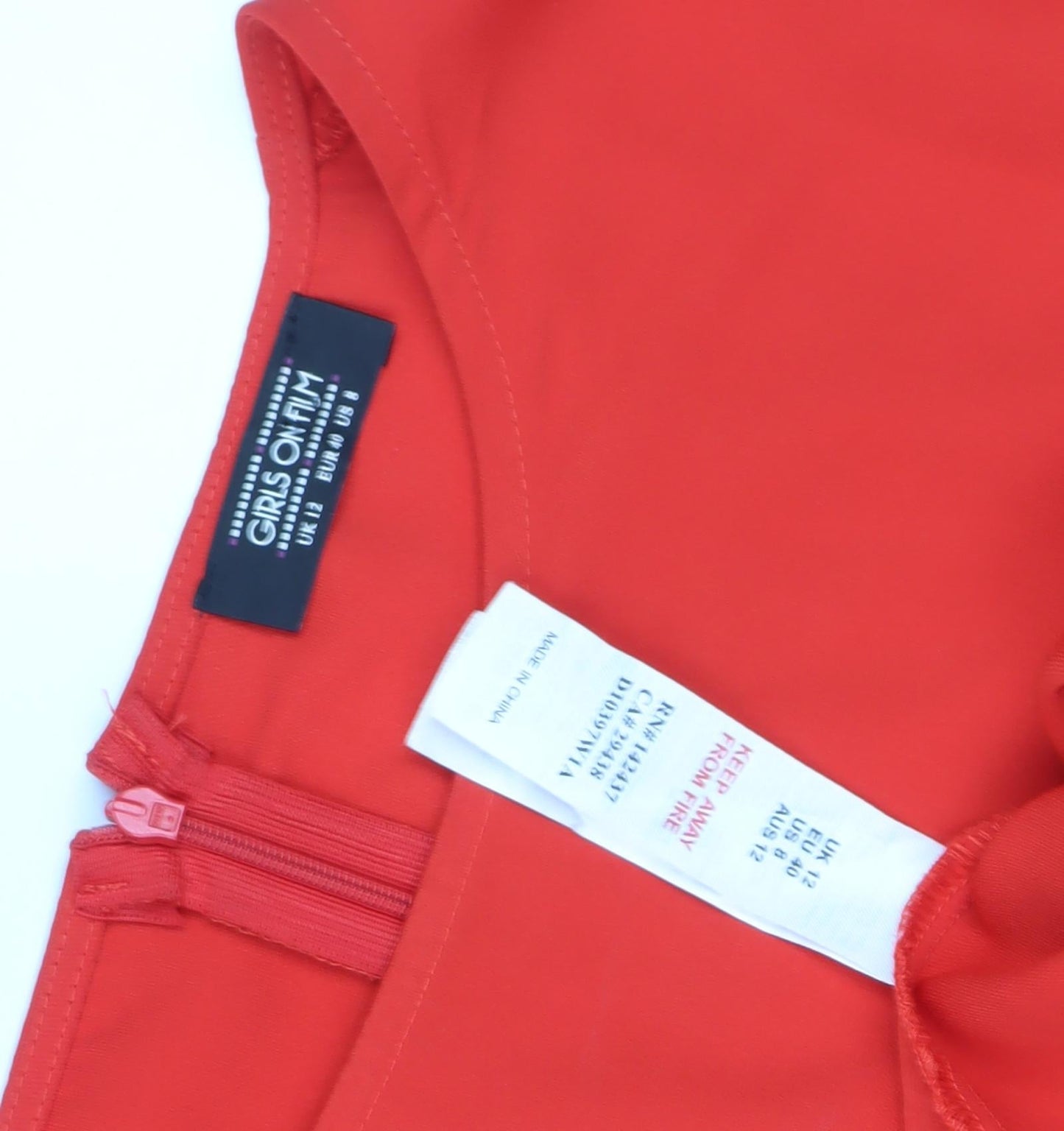 Close-up detail of girls’ on film red flutter sleeve fit & flare dress