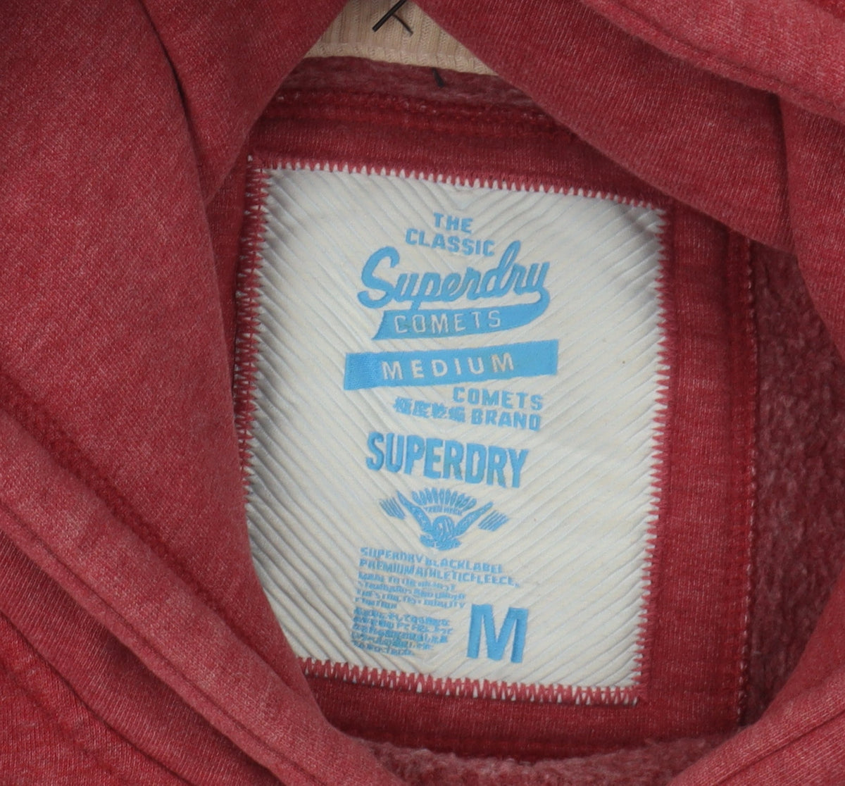 Close-up detail of Superdry unisex red pullover hoodie m - casual sportswear