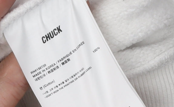 Brand and care label for Chuck White unisex sweatshirt, size S, cotton, new