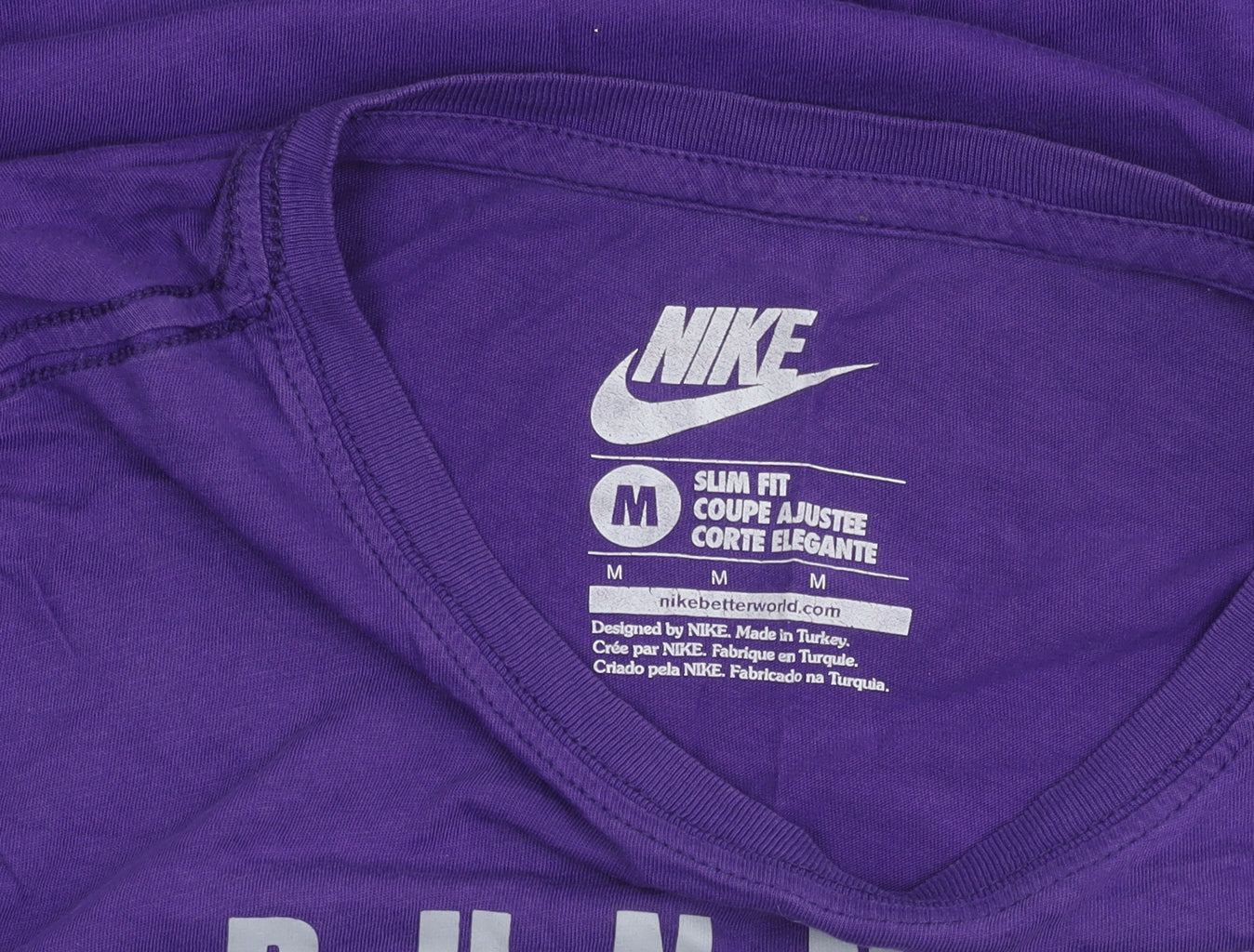 Brand and care label for Nike unisex purple slim fit t-shirt m