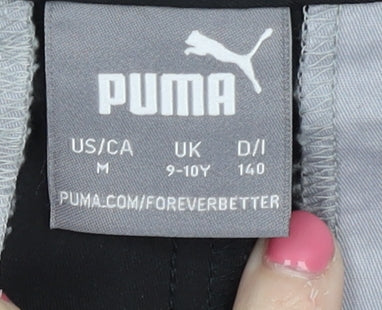 Brand and care label for Puma boys’ black trousers, size 9-10, years polyester