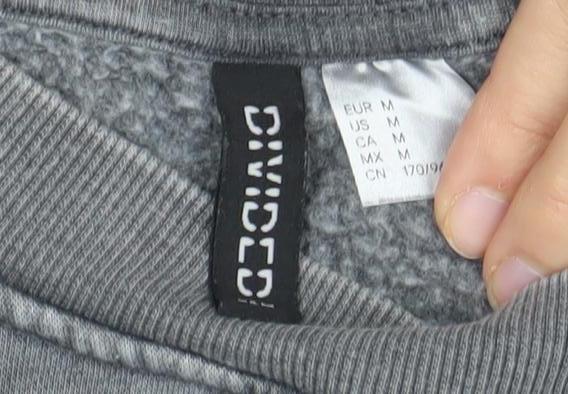 Close-up detail of Divided unisex grey pullover sweatshirt, size 12