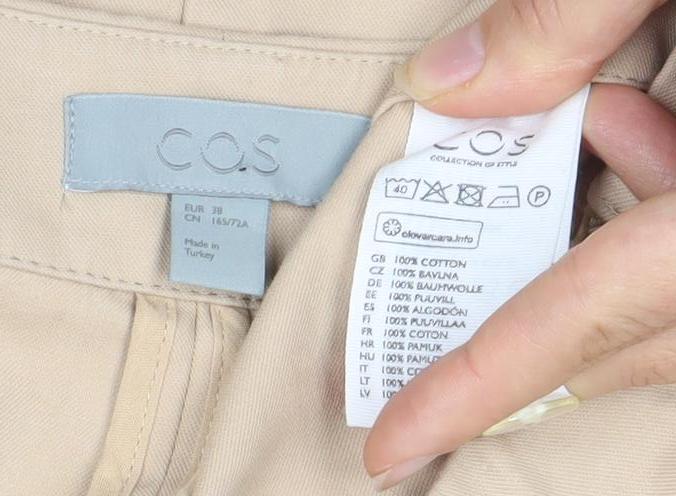 Close-up detail of COS Women's Beige Cotton Skirt, size 10, with Pockets
