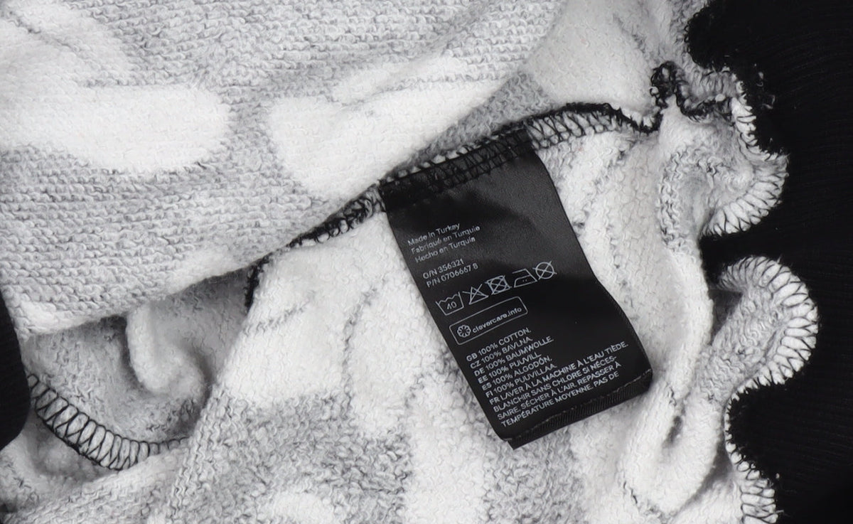 Brand and care label for H&M unisex disney black graphic sweatshirt, size 12