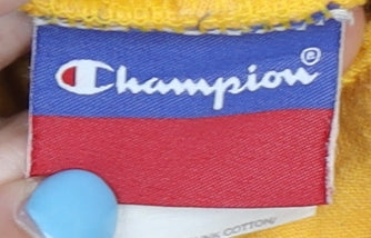 Brand and care label for Champion unisex yellow pullover hoodie, size S