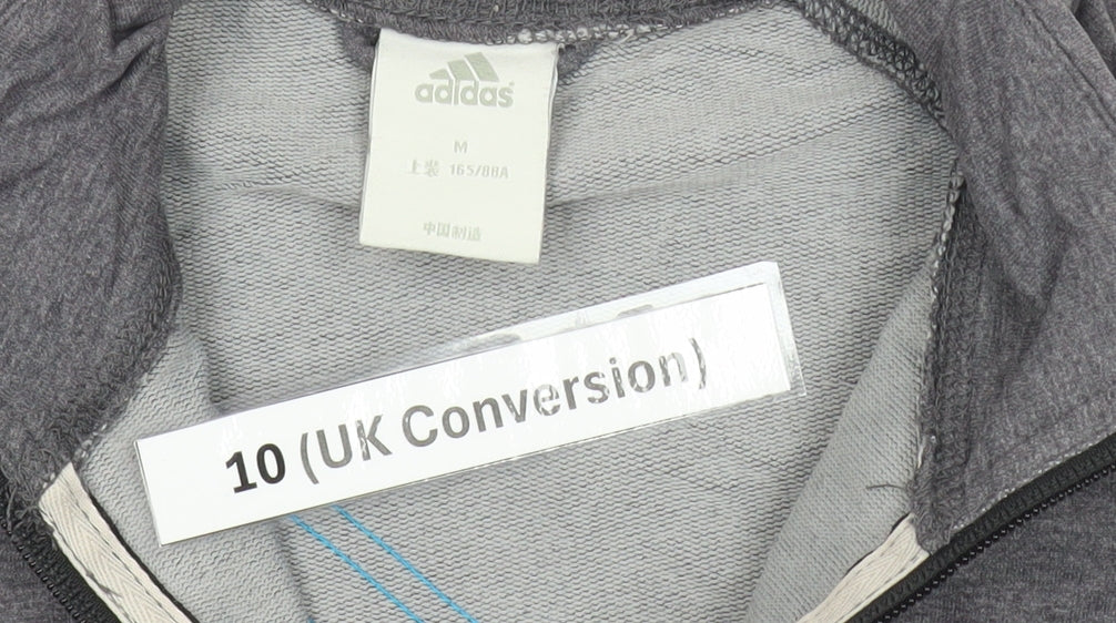 Brand and care label for Adidas women’s grey track jacket, size UK 10 slim, fit lightweight sportswear