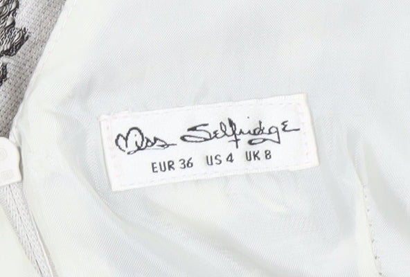 Brand and care label for Miss Selfridge women’s ivory floral jacquard fit & flare dress, size UK 8