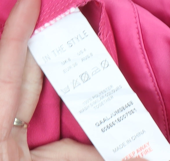 Brand and care label for In The Style Women’s Pink Halter Wide-Leg Jumpsuit, size UK 8