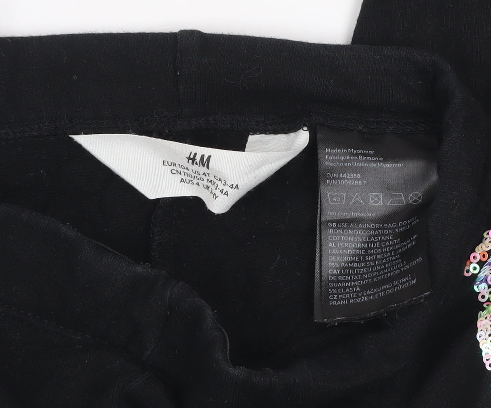 Brand and care label for H&M girls’ black floral side stripe cotton stretch ankle leggings 4 years