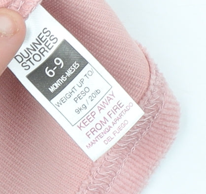 Brand and care label for Dunnes girls’ pink corduroy sleeveless a-line dress 6-9 months
