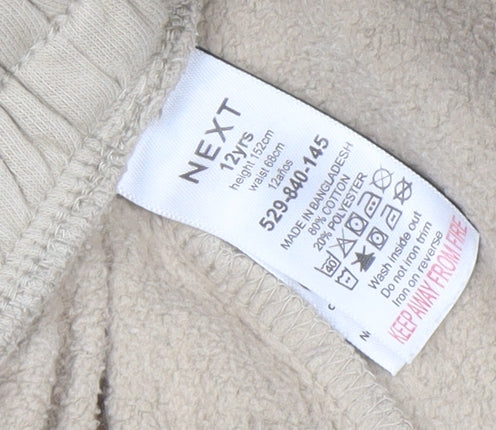 Brand and care label for Next boys’ beige jogger trousers 12 years cotton blend fleece casual