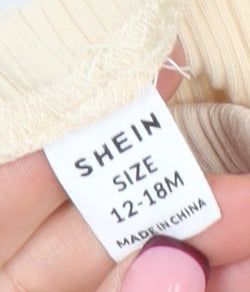 Brand and care label for SHEIN unisex baby beige ribbed leggings 12-18 months cotton stretch