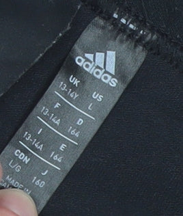 Brand and care label for Adidas girls’ black 13-14 years ankle leggings stretch cotton blend